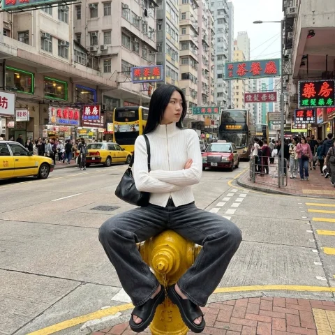 Confident Girl Neon Street — Nano Banana 2 AI Prompt: { "image_generation": { "subject": { "description": "young woman sit...