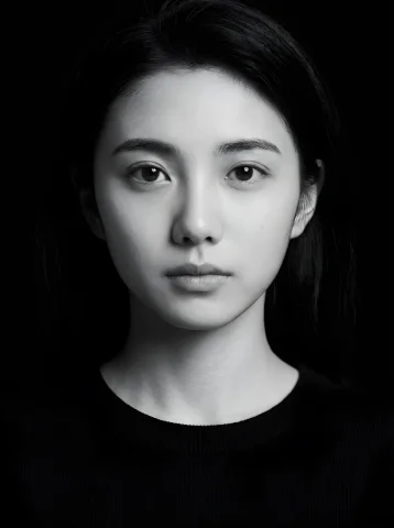 A Black and White Studio Portrait — Nano Banana 2 AI Prompt: Black and white studio portrait of the young woman in the uploaded image, lookin...