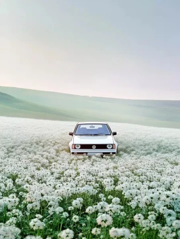 Surreal Golf GTI in Flowers — Midjourney v6 AI Prompt: a surrealistic beautiful arty photo of a white 1990 Volkswagen Golf GTI in an en...