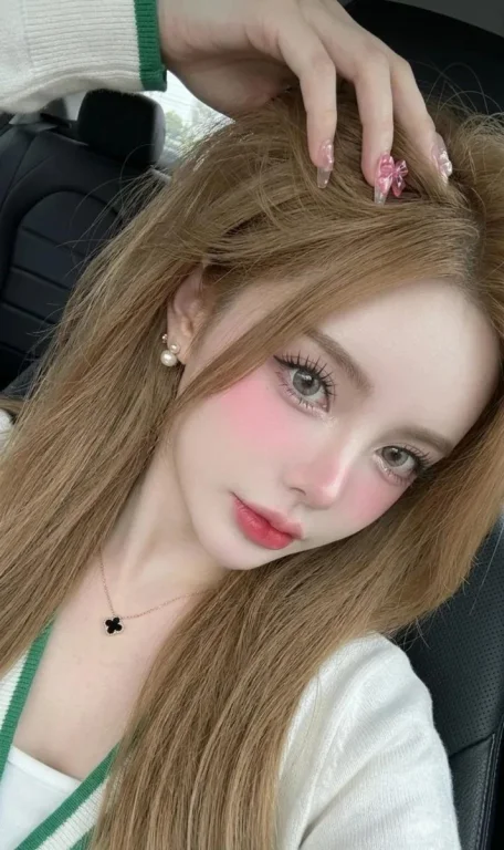 Woman captures a glowing selfie inside a sleek car interior