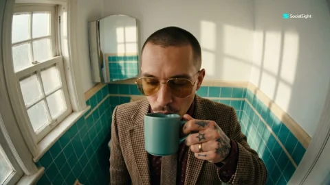 Man sips espresso in vintage bathroom with fisheye lens — Nano Banana 2 AI Prompt: Ultra wide fisheye lens shot from a high overhead angle looking down at a stylis...