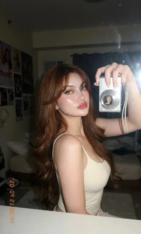 Candid woman in dark room with flash and glossy lips