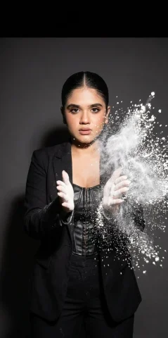Flour Power: A Moment of Enchantment — Nano Banana 2 AI Prompt: atmospheric studio action shot, dark solid background, harsh high-contrast flash...