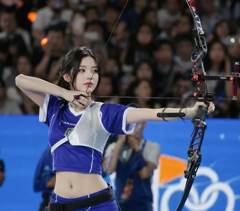Precision in Motion: The Archer's Poise — Nano Banana 2 AI Prompt: Ultra realistic sports photography, young East Asian female archer standing in a...