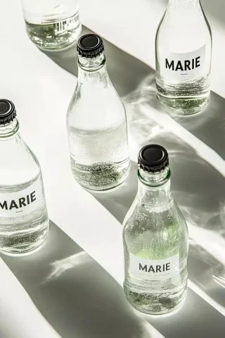 Hyper-Realistic Sparkling Water — Midjourney v6 AI Prompt: Product photography, a product shot of sparkling water in glass bottles with the...