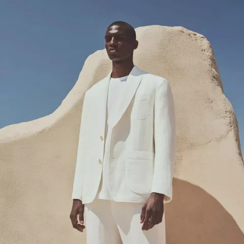 Minimalist Deconstructed White Jacket — Midjourney v6 AI Prompt: Summer campaign photo of a white deconstructed jacket with a minimalist cut. Wit...