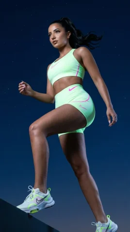 Futuristic Power in Motion — Nano Banana 2 AI Prompt: Nike Pro inspired premium campaign photo of an athletic woman shot from a dramat...