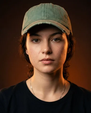 Ultra-Realistic Cinematic Portrait with Dramatic Orange Lighting — Nano Banana 2 AI Prompt: cinematic close-up portrait of a woman wearing a faded green baseball cap, black...