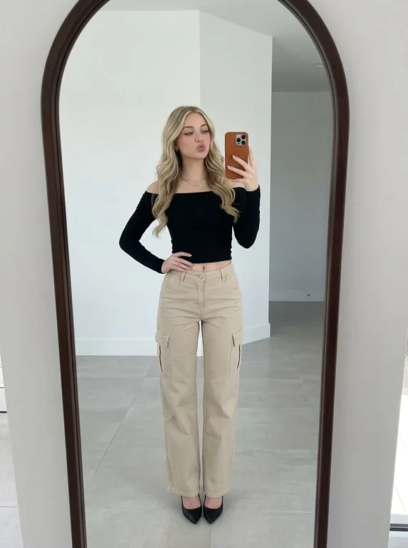 Confident Reflection: Young Woman's Bold Mirror Selfie