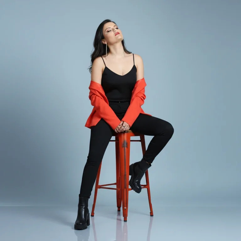 A High-Fashion Studio Photograph Featuring A Female Figure Seated