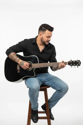 A Full-Length Studio Photograph Capturing A Male Figure With A Re — Nano Banana Pro AI Prompt: A full-length studio photograph capturing a male figure with a relaxed, musical...
