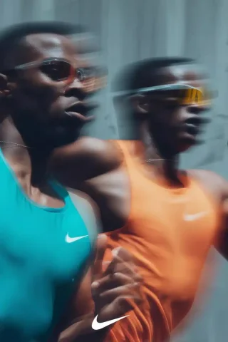 Dynamic Sprinters in Cityscape — Midjourney v6 AI Prompt: stylized high-motion editorial full body photo of two male sprinters racing in c...