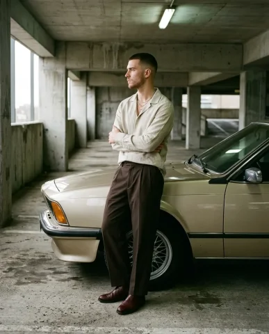 Luxury Sedan Editorial Menswear 5 — Nano Banana AI Prompt: Side-profile editorial menswear photograph inside a raw poured-concrete parking...