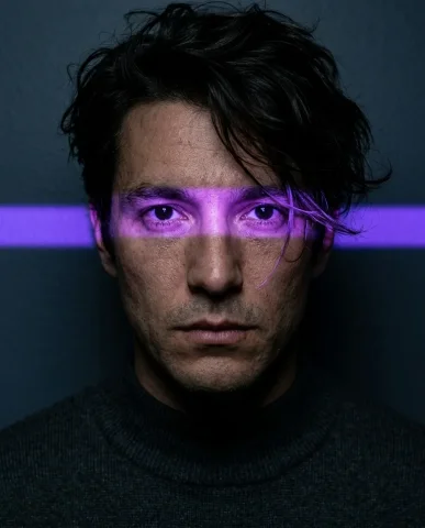 Neon Eye-Line Dramatic Portrait 1 — Nano Banana AI Prompt: Ultra-realistic dramatic portrait of a person with tousled dark hair swept acros...