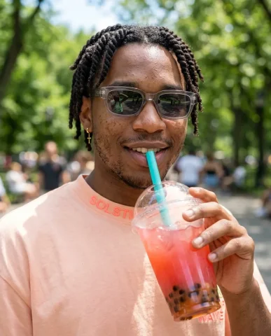 Summer Streetwear Boba Portrait 2 — Nano Banana AI Prompt: Stylish Black man in a peach Solstice Wave t-shirt holding strawberry boba tea u...