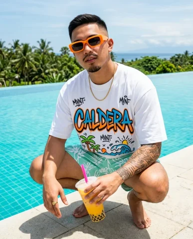 Poolside Boba Streetwear Editorial 1 — Nano Banana AI Prompt: Wearing an oversized white t-shirt with bold hand-lettered graffiti text "CALDER...