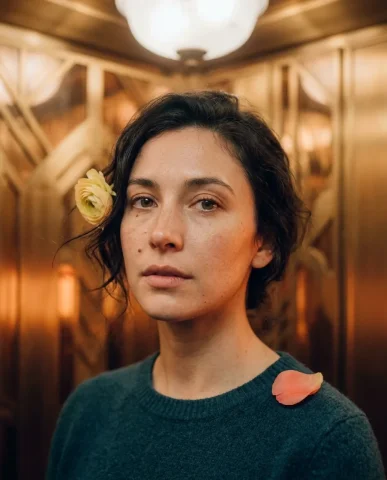 Elevator Flower Surreal 2 — Nano Banana AI Prompt: Portrait from a slightly elevated angle of a person with distinctive features st...