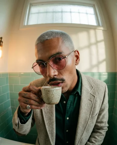 Fisheye Coffee Sip Bathroom Portrait 1 — Nano Banana AI Prompt: Ultra-realistic editorial close-up portrait in a vintage powder room. A striking...