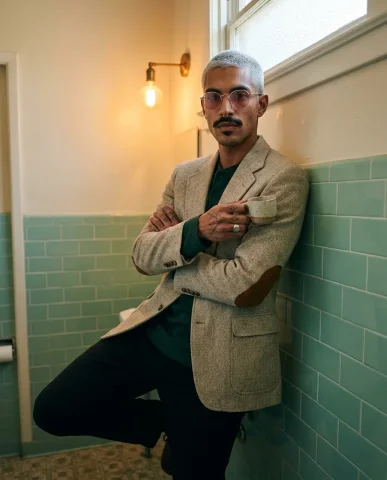 Fisheye Coffee Sip Bathroom Portrait 6 — Nano Banana AI Prompt: The cuff of a rumpled oatmeal-tweed blazer with elbow patches and the sleeve of...