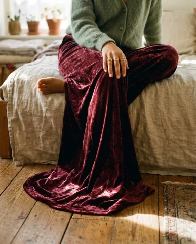 Gold Jewelry and Velvet Texture Detail Shot 6 — Nano Banana AI Prompt: Overhead wide shot from directly above of a figure seated on a linen-covered day...