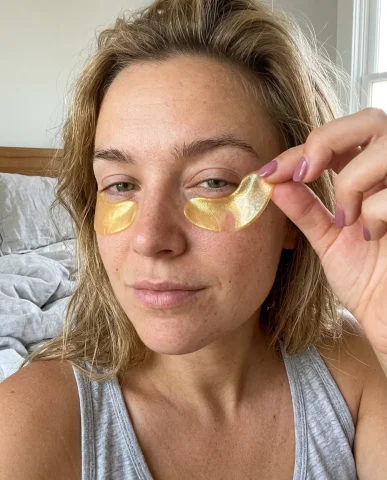 Morning Skincare Selfie with Under-Eye Patches 6 — Nano Banana AI Prompt: Selfie close-up of a woman sipping through the bamboo straw of a clear reusable...