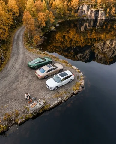 Grand Touring Cars at Misty Norwegian Fjord 6 — Nano Banana AI Prompt: Ultra-realistic close-up detail shot at a Norwegian fjord on a misty morning. A...