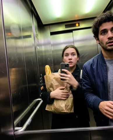Accidental Elevator Selfie with a Friend 1 — Nano Banana AI Prompt: The main subject has shifted the crumpled brown paper grocery bag with the protr...
