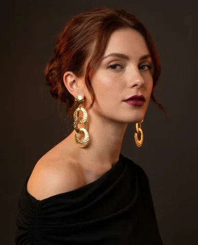 Valentino Style Gold Statement Earrings Portrait 1 — Nano Banana AI Prompt: Soft directional light from camera-left sculpts the jawline and ear. The focal p...
