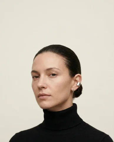 The Row Style Minimalist Sculptural Earrings Portrait 1 — Nano Banana AI Prompt: Makeup nearly invisible — clean hydrated skin with a matte finish. Both ultra-mi...