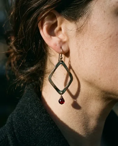 Celine Style Effortless Gold Earrings Close-Up 2 — Nano Banana AI Prompt: The oxidized bronze surfaces show the full patina — warm brown, hints of green o...