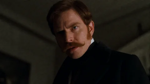 Mlnrg2001, A Man With Reddish-brown Hair And A Thick, Curled... — Stable Diffusion AI Prompt: mlnrg2001, A man with reddish-brown hair and a thick, curled mustache stares int...