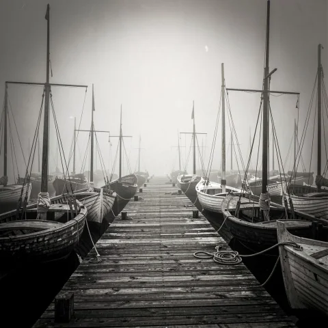 A Foggy Pier Crowded With Old Wooden Boats, Editorial Photog... — Stable Diffusion AI Prompt: a foggy pier crowded with old wooden boats, editorial photography, dramatic chia...