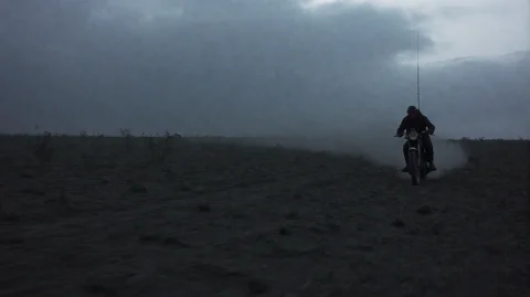 Rgnfr2002, A Lone Rider On A Motorcycle Traverses A Barren,... — Stable Diffusion AI Prompt: rgnfr2002, A lone rider on a motorcycle traverses a barren, uneven field under a...