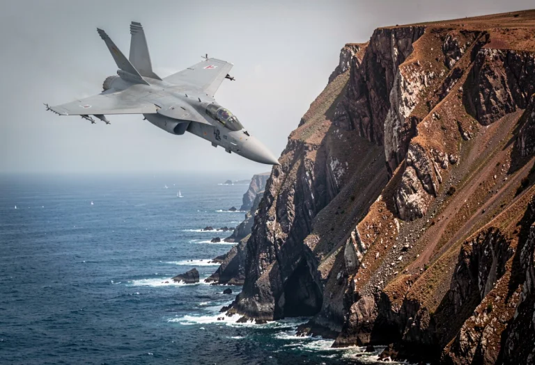 A Fighter Jet Banking Over A Rugged Coastline, Portrait Phot...