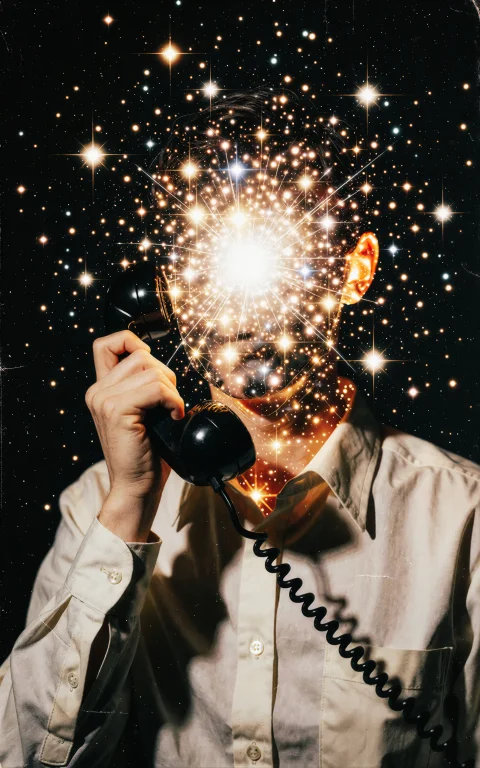A Person In A Vintage Button-down Shirt Holding A Black Cord...