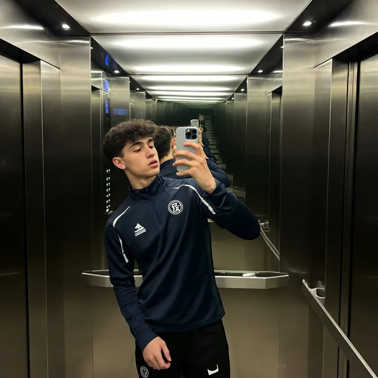 23yo Boy In A Sportswear Creating A Selfie In The Elevator W...
