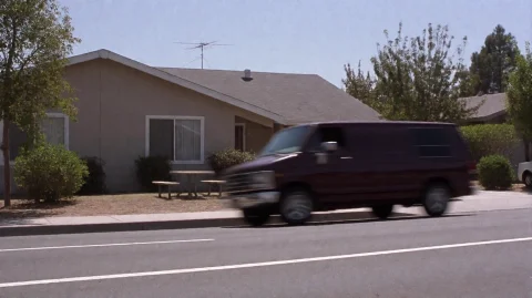 Scrtry2002, A Dark-colored Van Moves Swiftly Past A Single-s... — Stable Diffusion AI Prompt: scrtry2002, A dark-colored van moves swiftly past a single-story beige house wit...