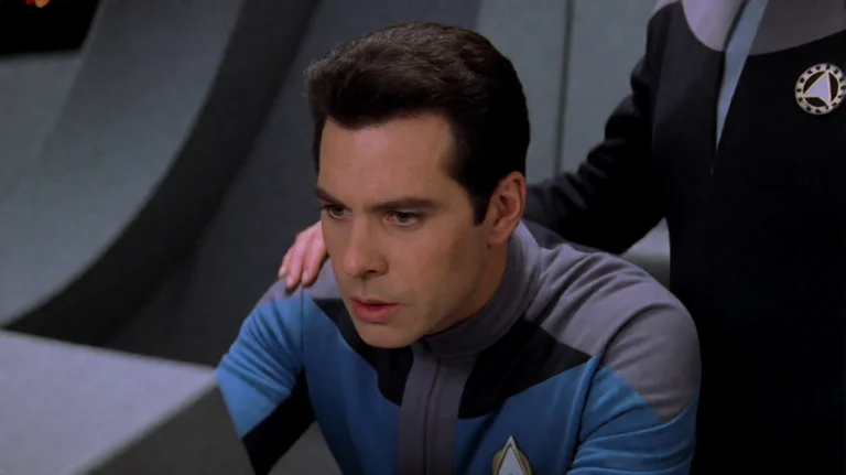 Glxyqst1999, A Man In A Blue And Gray Uniform Leans Forward...