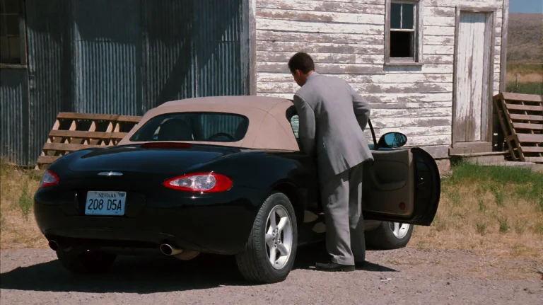 Mmnt2000, A Man In A Light Gray Suit Is Stepping Out Of The...
