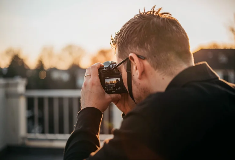 A Photographer Framing A Shot At Golden Hour, Soft Diffused...
