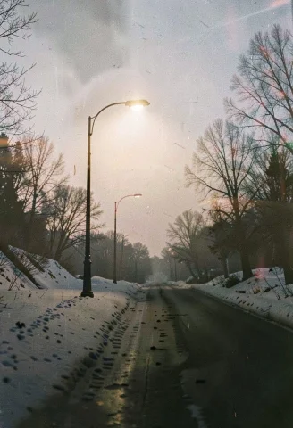 A Lone Streetlight Glowing On A Snowy Road, 35mm Film Still,... — Stable Diffusion AI Prompt: a lone streetlight glowing on a snowy road, 35mm film still, backlit silhouette,...