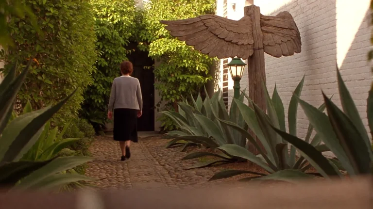 Scrtry2002, A Woman In A Gray Cardigan And Black Skirt Walks...