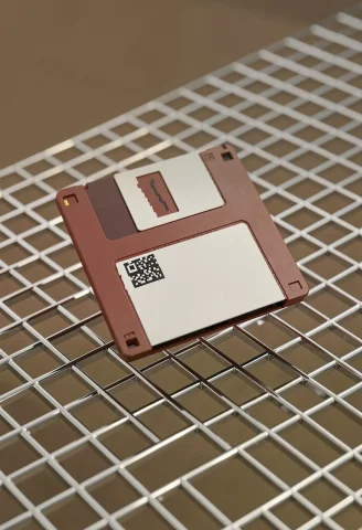 A Floppy Disk Floating Over A Chrome Grid, Pixel Art, Close-... — Stable Diffusion AI Prompt: a floppy disk floating over a chrome grid, pixel art, close-up, muted earth tone...
