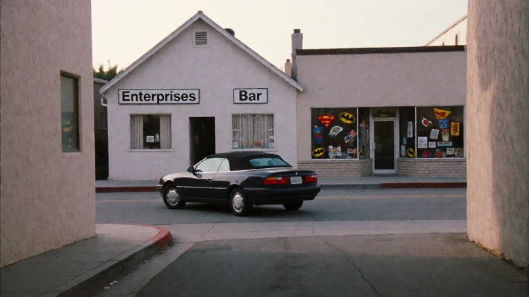 Mmnt2000, A Dark Convertible Car Is Captured Mid-turn On A Q...