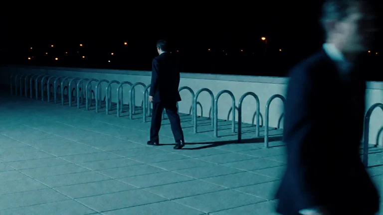 Insdr1999, A Solitary Figure In A Dark Suit Walks Purposeful...