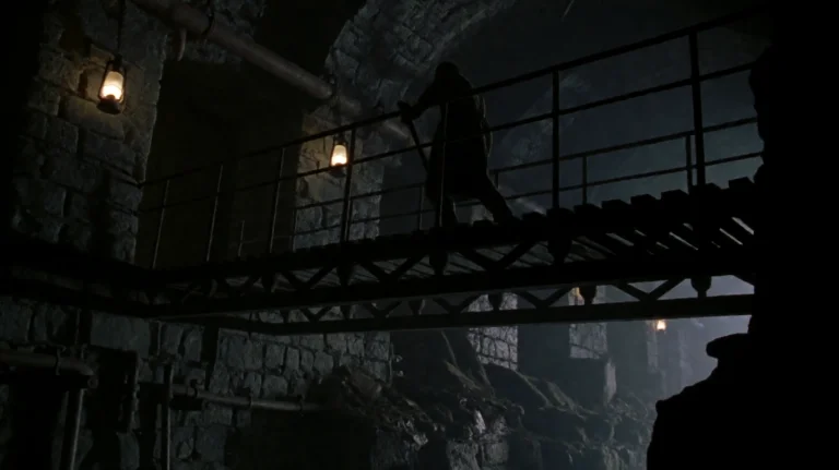 Cntmntcrst2002, A Lone Figure, Silhouetted Against Dim Light...