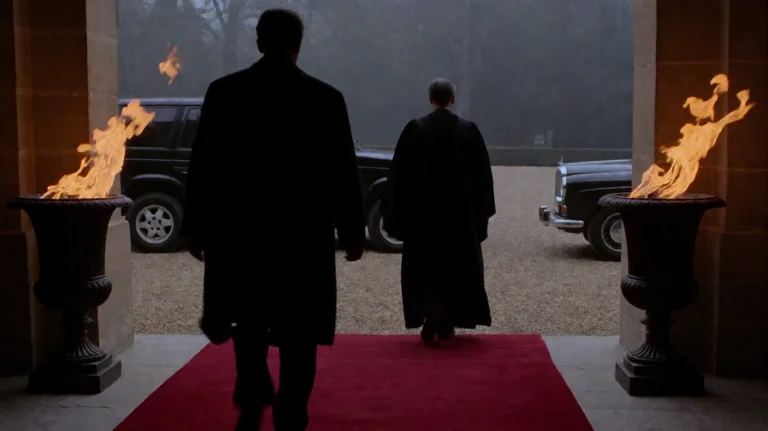 Nnthgt1999, A Silhouetted Figure In A Dark Coat Strides Forw...
