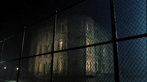Grnml1999, A Large, Ornate Building Stands Behind A Chain-li... — Stable Diffusion AI Prompt: grnml1999, A large, ornate building stands behind a chain-link fence under a dar...