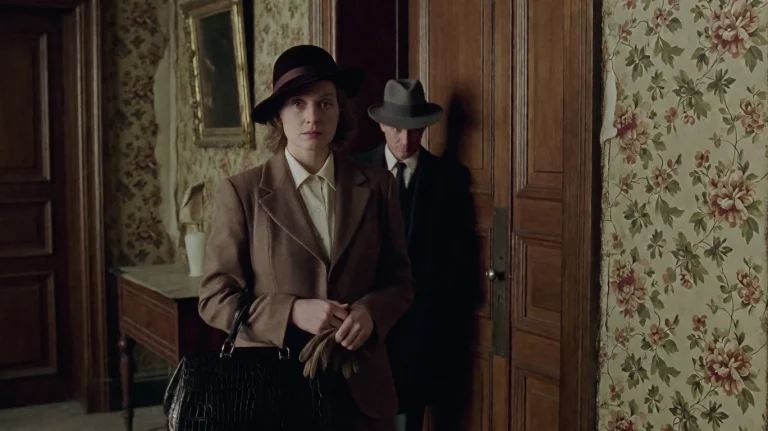 Pnst2002, A Woman In A Brown Hat And Matching Blazer Stands...