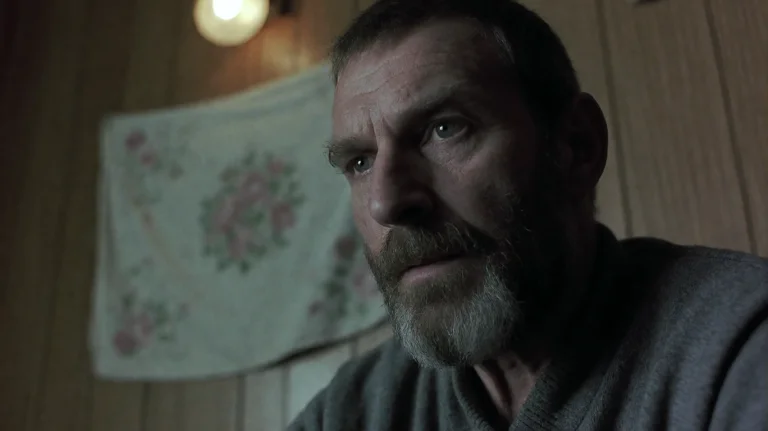 Sntch2000, A Weathered Man With A Grizzled Beard And A Small...